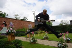Ian jumping playing guitar